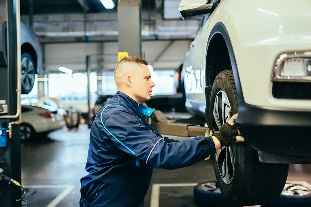 Automotive mechanic repairing a tire