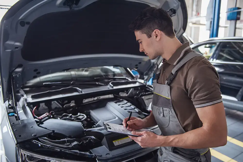 Mechanic performing vehicle maintenance