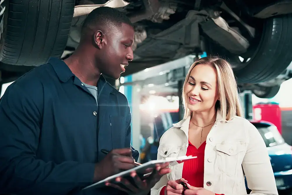 Professional mechanic explaining warranty coverage
